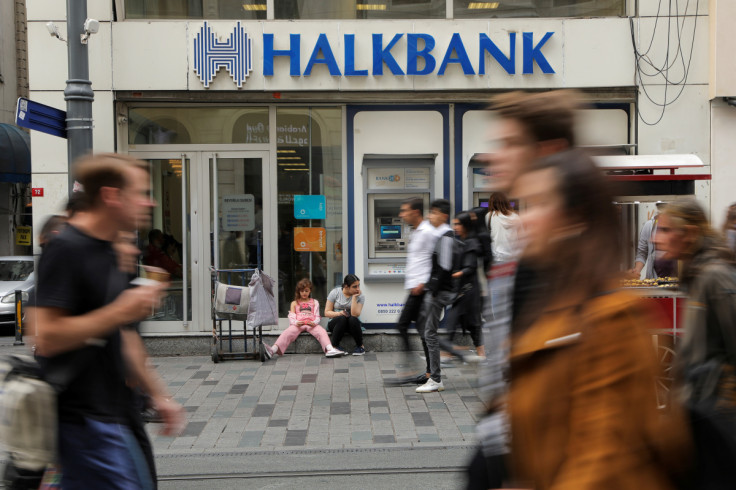 People walk by a branch of Halkbank in Istanbul