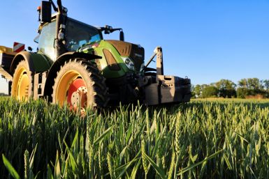 A farmer spreads nitrogen fertilizer on his wheat field, in Inchy-en-Artois