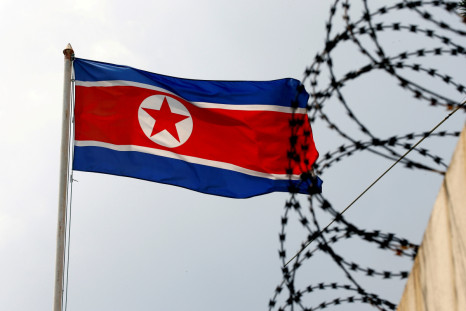 A North Korea flag flutters next to concertina wire at the North Korean embassy in Kuala Lumpur