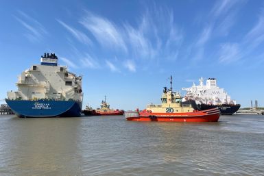 An LNG tanker is guided by tug boats at the Cheniere Sabine Pass LNG export unit in Cameron Parish, Louisiana
