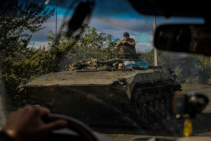 A Ukrainian APC rolls down a road at a position along the front line in the Donetsk region of Ukraine