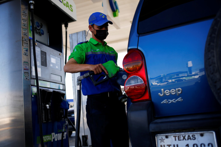 A worker fills a car belonging to a Texas resident with gasoline at a gas station following increased fuel prices in U.S., in Ciudad Juarez