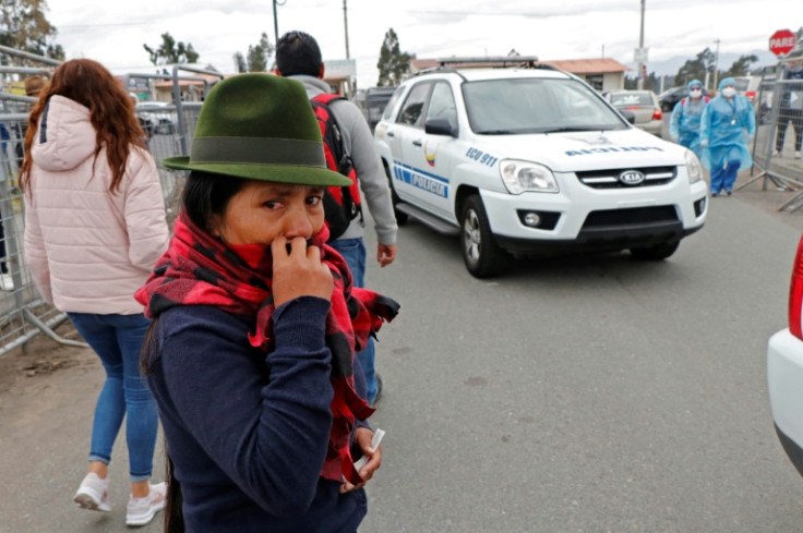 A relative of an inmate waits for news of her loved one after fresh clashes inside