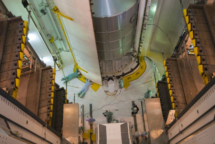 In Launch Pad 39A&#039;s payload changeout room at NASA&#039;s Kennedy Space Center in Florida, technicians close space shuttle Atlantis&#039; payload bay doors in preparation for launch. Image credit: NASA/Jim Grossmann