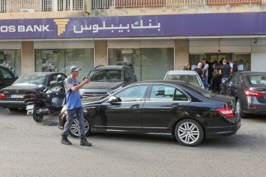 People stand outside a Byblos bank branch in Antelias