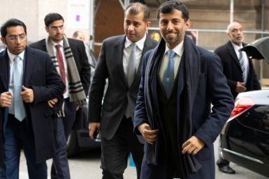 UAE Energy Minister Suhail al-Mazrouei (R) says OPEC+ is still reviewing market data