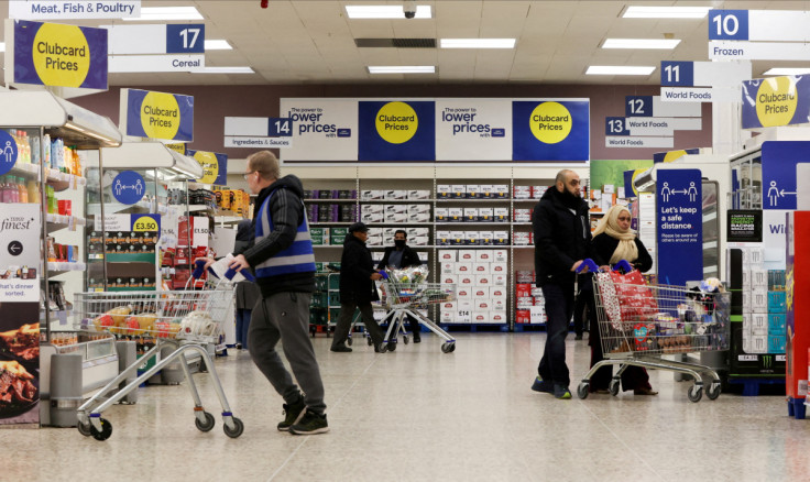 Clubcard branding is seen inside a branch of a Tesco Extra supermarket in London