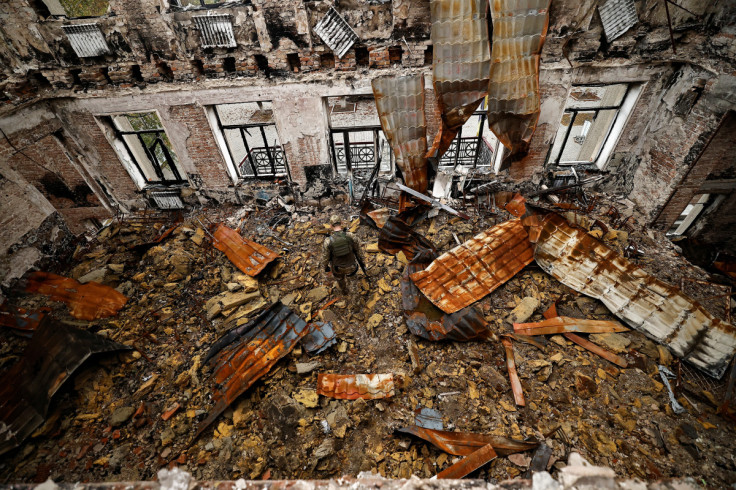 A military officer walks among the remains of a school that was destroyed during the fighting between Russian troops and the Ukrainian army, amid Russia's invasion of Ukraine, in the recently liberated town of Lyman