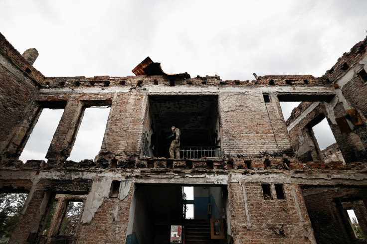 Illia Yerlash, a Ukrainian army officer, stands among the remains of a school that was destroyed during the fighting between Russian troops and the Ukrainian army, amid Russia's invasion of Ukraine, in the recently liberated town of Lyman