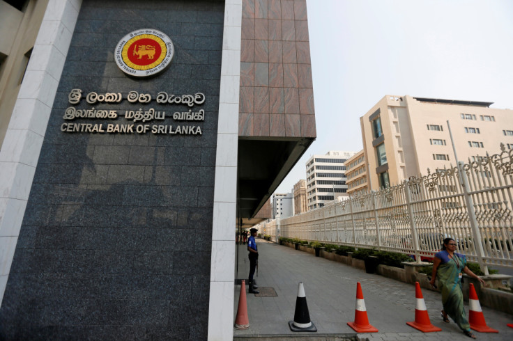 A woman walks past the main entrance of the Sri Lanka's Central Bank in Colombo, Sri Lanka