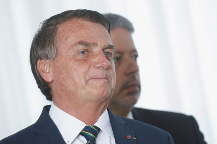 Brazil's President and candidate for re-election Jair Bolsonaro and Lower House President Arthur Lira attend a meeting with elected parliamentarians and governors who support Bolsonaro at the Alvorada Palace in Brasilia