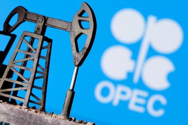 A 3D printed oil pump jack in front of the OPEC logo