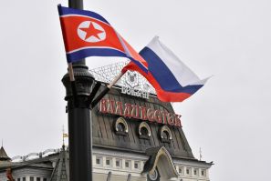 State flags of Russia and North Korea fly in a street in Vladivostok