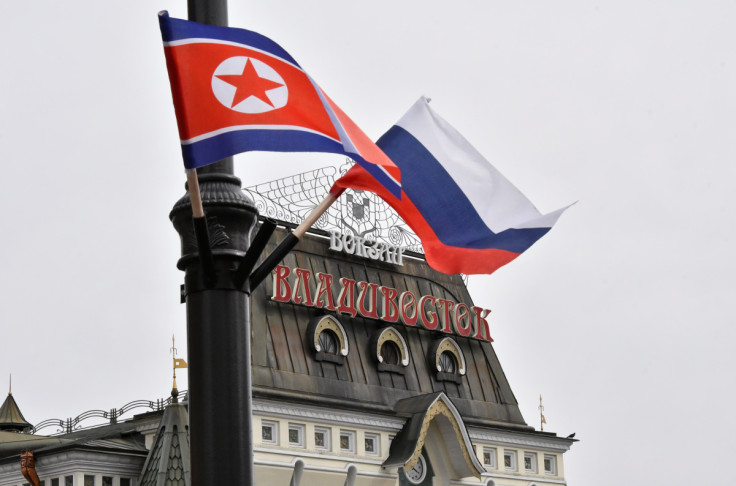 State flags of Russia and North Korea fly in a street in Vladivostok