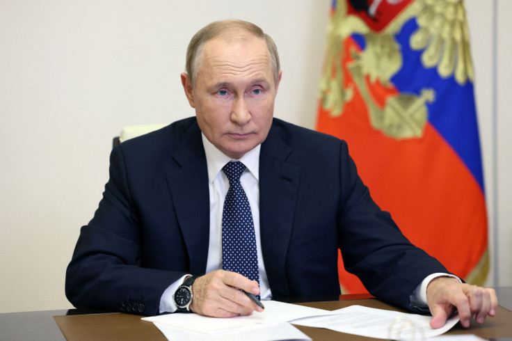 Russian President Vladimir Putin takes part in a video conference with a group of award-winning teachers