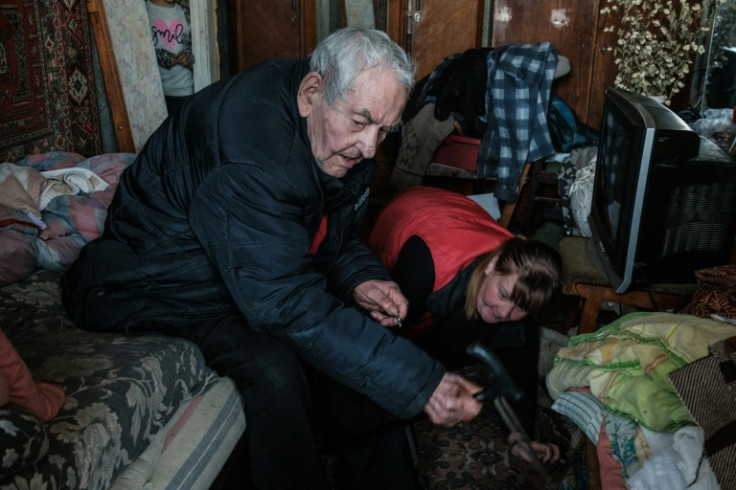 Ivan Solovyankov, 90, asks a family member to find his dog as he evacuates from his apartment in Bakhmut