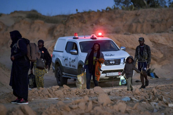 Members of Tunisia's National Guard clear migrants from an olive grove by the sea north of Sfax, suspecting them of preparing to board a vessel leaving clandestinely for Italy