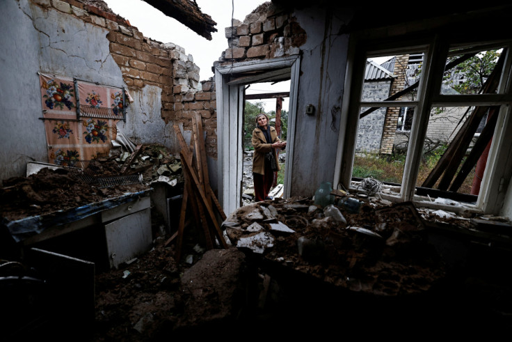 Inna, 51, stands outside her summer kitchen that was destroyed during the fighting between Russian troops and Ukrainian army, in the newly recaptured town of Yarova