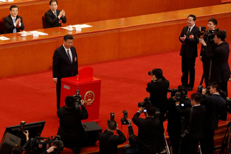 Chinese President Xi Jinping pauses after casting his ballot in Beijing