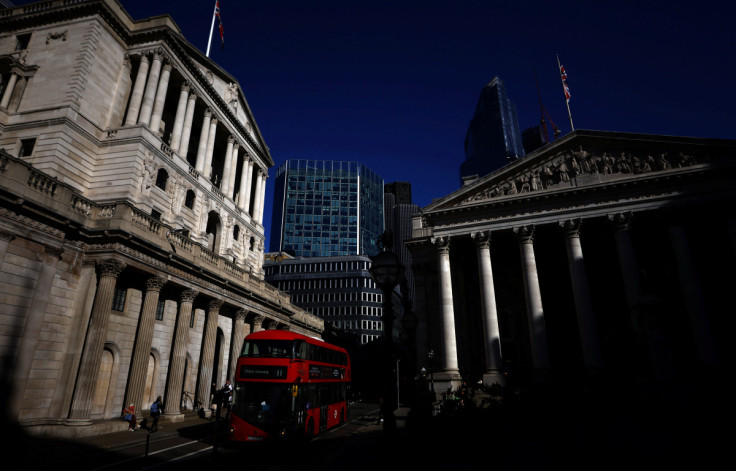 People walk outside the Bank of England in London