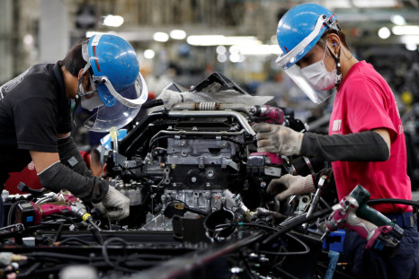 Employees work on the automobile assembly line at Kawasaki factory of Mitsubishi Fuso Truck and Bus Corp in Kawasaki