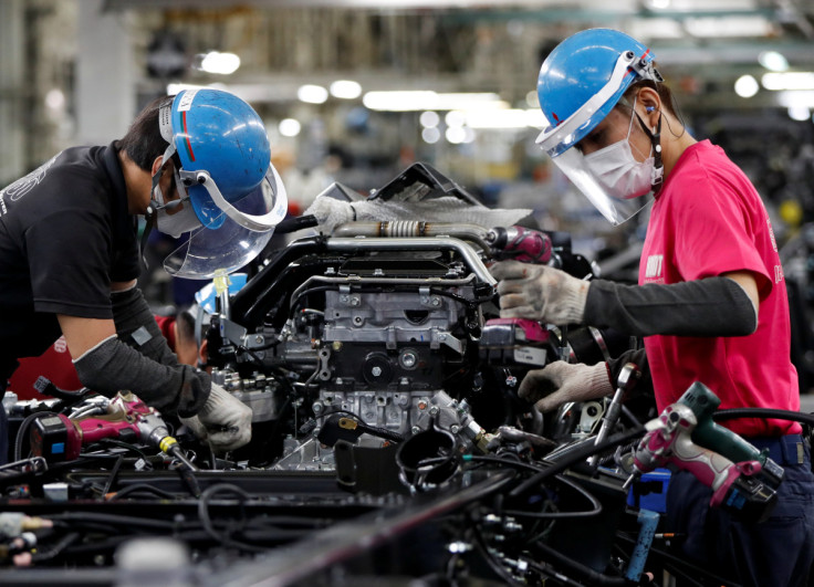 Employees work on the automobile assembly line at Kawasaki factory of Mitsubishi Fuso Truck and Bus Corp in Kawasaki