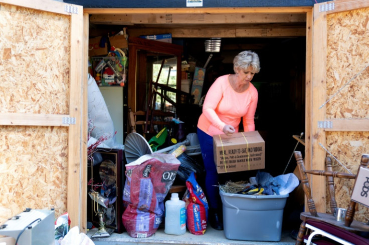 Christy White salvages items from a shed outside her flooded home in Lost Creek, Kentucky, September 29, 2022