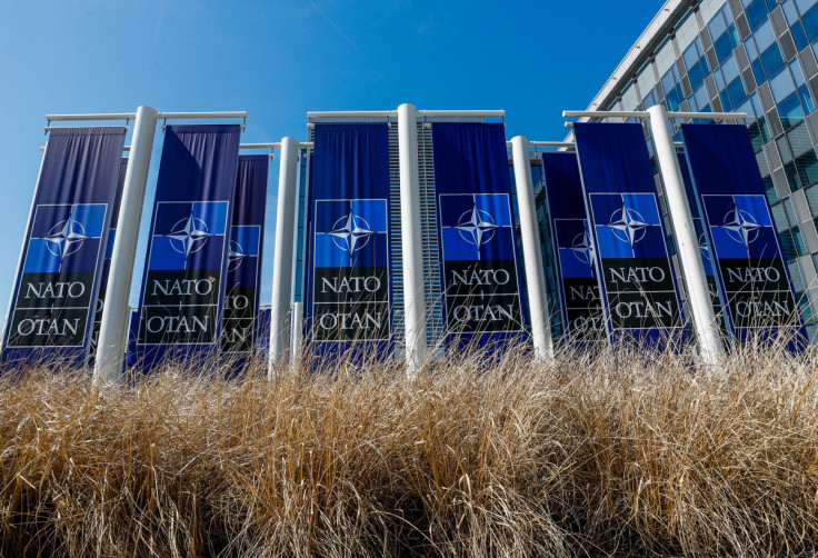 Banners displaying the NATO logo are placed at the entrance of new NATO headquarters during the move to the new building