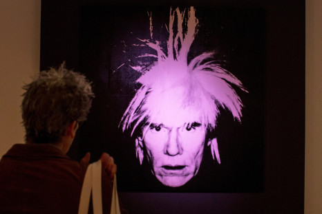 A man examines "Self-Portrait" by Andy Warhol during a media preview at Christie's auction house in New York