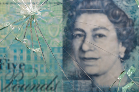 British pound banknote is pictured through broken glass in this illustration