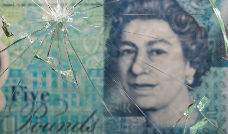 British pound banknote is pictured through broken glass in this illustration