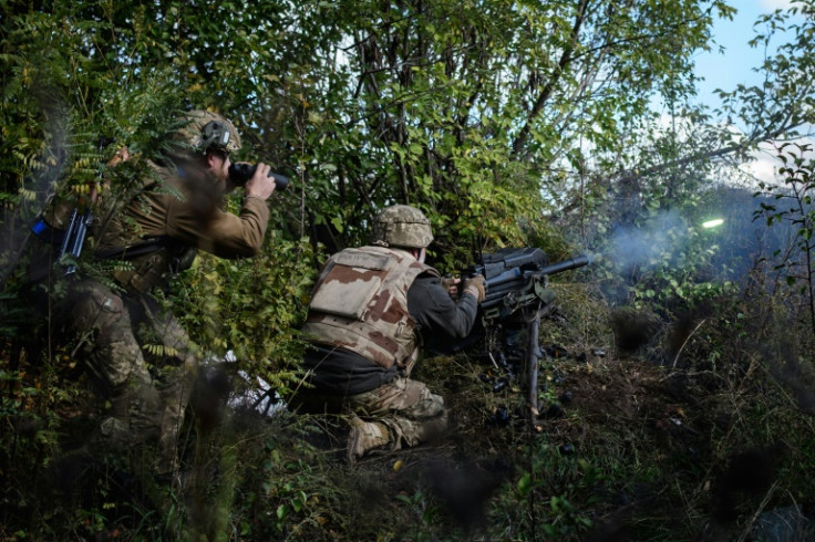 Soldier of Ukraine's 5th Regiment of Assault Infantry react after firing a US-made MK-19 automatic grenade launcher towards Russian positions in less than 800 metres away at a front line near Toretsk in the Donetsk region