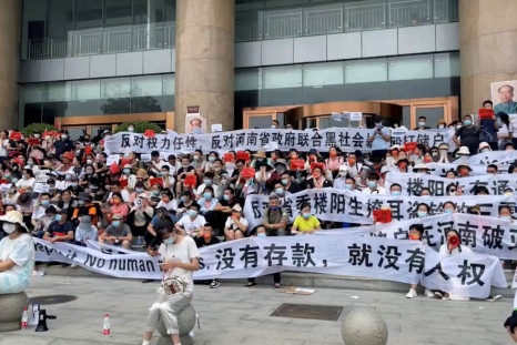 People protest over the freezing of deposits by rural-based banks, outside a People's Bank of China building in Zhengzhou