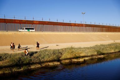 Asylum-seeking migrants from Venezuela cross the Rio Bravo river to turn themselves in to U.S. Border Patrol agents to request asylum in El Paso, Texas, U.S., as seen from Ciudad Juarez