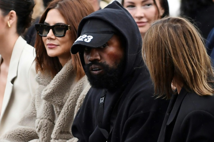US rapper Kanye West (C), attends a fashion show during the Paris Womenswear Fashion Week, in Paris, on October 2, 2022