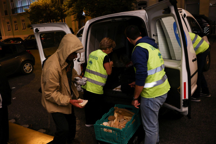 A person holds a meal pack from homeless charity CASA in central Lisbon