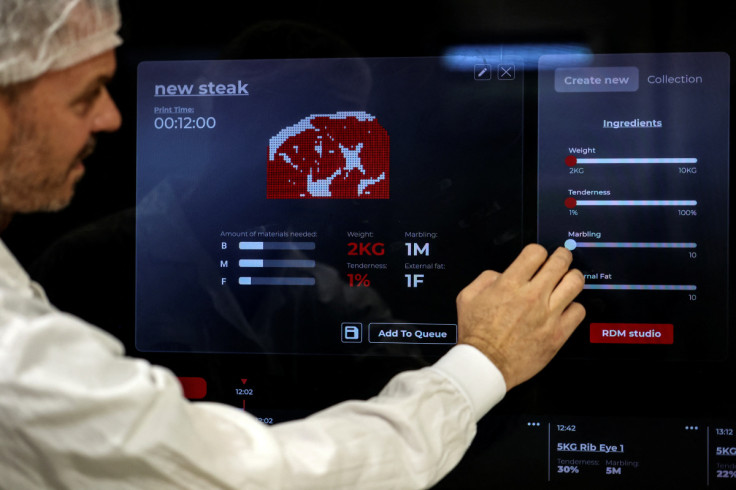 A worker configures a large-scale "Angus" meat printer to produce 3D printed plant-based vegan meat at the offices of Israeli start-up Redefine Meat in Rehovot