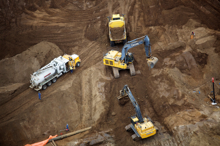 Heavy earth moving equipment work clearing an area at the new Suncor Fort Hills tar sands mining operations near Fort McMurray.