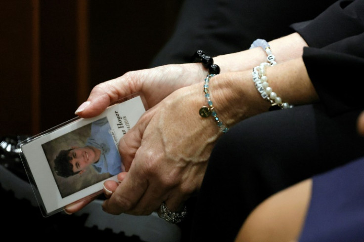 Gena Hoyer holds a photograph of her son, Luke, who was killed in the 2018 shooting at Marjory Stoneman Douglas High School in Parkland, Florida