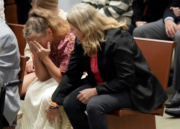 Debbie Hixon reaches out to her sister-in-law, Natalie Hixon, as the verdicts are announced in the trial of Parkland shooter Nikolas Cruz