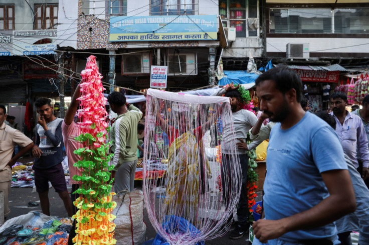 People shop at a crowded market ahead of Diwali, the Hindu festival of lights, in the old quarters of Delhi