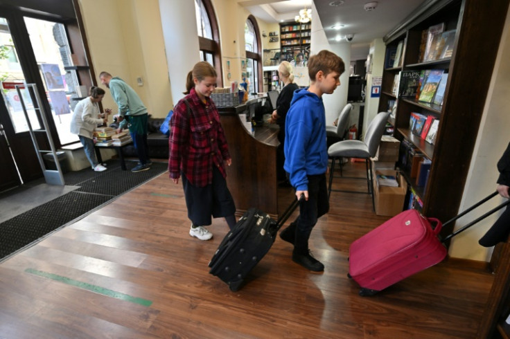 People haul piles of Russian-language books, sometimes by the suitcase or car-load, for recycling