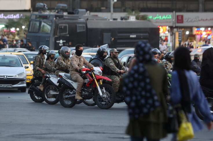 Riot police officers ride motorcycles in a street in Tehran, Iran