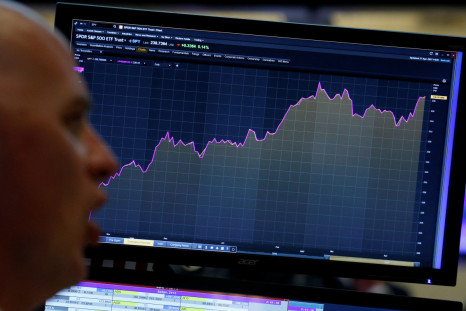 A trader looks at a screen that charts the S&P 500 on the floor in New York
