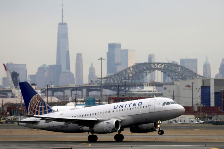 A United Airlines passenger jet takes off with New York City as a backdrop