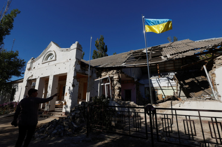 Ukrainian national flag rises over a local council headquarter building in the village of Lymany in Mykolaiv region