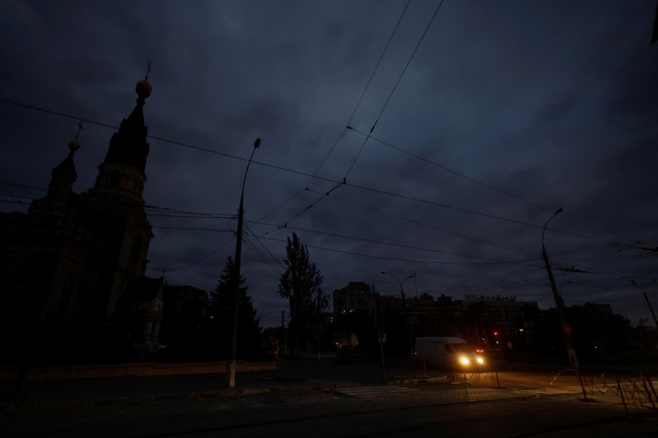 Van drives along a dark street during electricity shortage in Mykolaiv