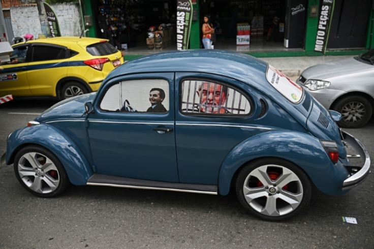 Fans of Brazilian President Jair Bolsonaro have taken to driving cars with images of him as a driver and his rival, leftist Luiz Inacio Lula da Silva, as a prisoner behind bars