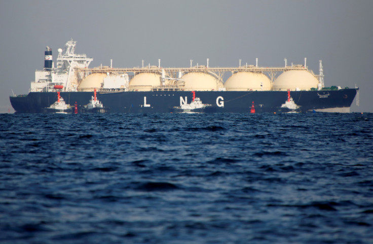 An LNG tanker is tugged towards a thermal power station in Futtsu