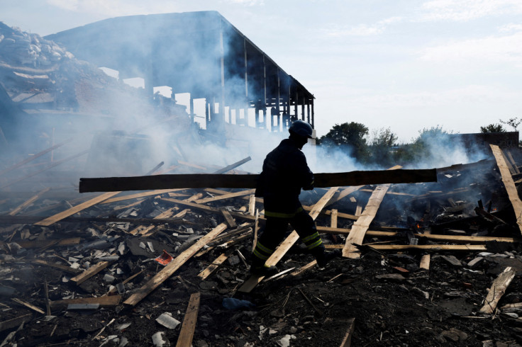 A Ukrainian firefighter removes rubbles in a factory destroyed by a Russian strike in the city of Slovyansk
